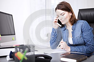 Serious businesswoman listening to a phone call