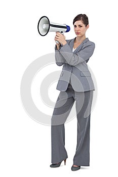 Serious businesswoman with loudspeaker