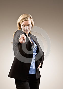 Serious businesswoman pointing accusing finger photo