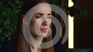 Serious businesswoman portrait. Employee sitting on sofa in home office