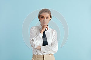 Serious Businesswoman Posing Studio. Portrait of Thoughtful Woman Standing