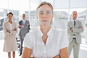 Serious businesswoman standing with arms folded