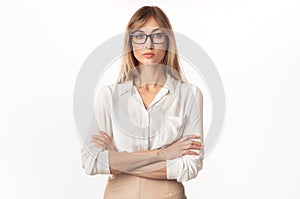 Serious Businesswoman Standing Crossing Hands On White Studio Background