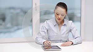 Serious businesswoman with tablet pc in office