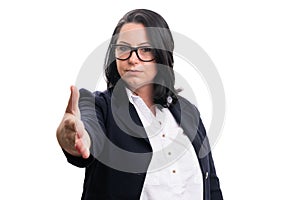 Serious businesswoman wearing glasses offering handshake