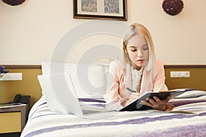 Serious businesswoman working with documents in hotel