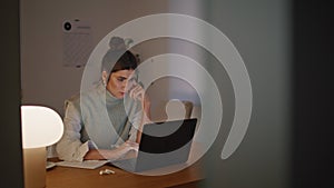 Serious businesswoman working laptop at night workplace closeup. Woman studying