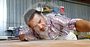 Serious carpenter checking his work