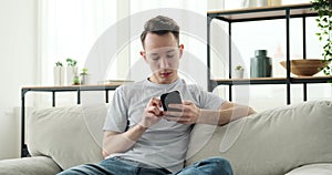 Serious Caucasian Man Engaged with Phone