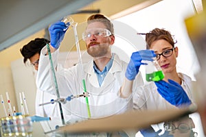 Serious clinicians studying chemical elements in laboratory