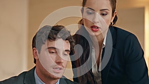 Serious colleagues analyzing business results in buro closeup. Office couple