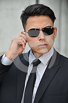 Serious Colombian Security Guard Surveillance Agent Wearing Sunglasses