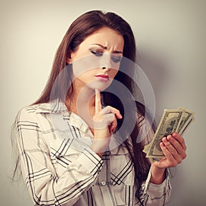 Serious concentrated thinking business woman thinking where invest money and how to earing more dollars. Toned closeup portrait