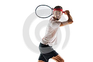 Serious and concentrated young man, tennis player during game, standing with racket, ready to hit ball isolated over