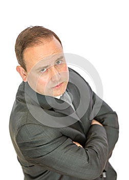 Serious, concerned businessman with crossed arms