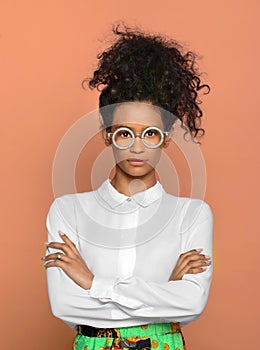 Serious confident black woman wearing round eyeglasses