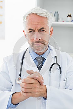 Serious confident male doctor at medical office