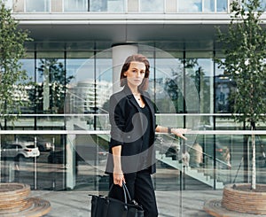 Serious and confident middle-aged woman wearing formal black clothes