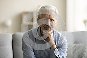 Serious confident senior retired man looking at camera