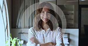 Serious confident young startup leader girl posing in office