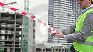 Serious construction superintendent cordoning off building site photo