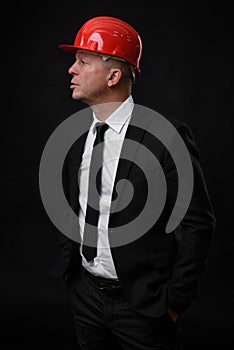 Serious construction worker in red helmet