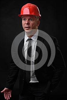 Serious construction worker in red helmet