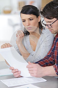serious couple looking at paperwork together