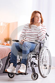 Serious crippled woman thinking in the wheelchair