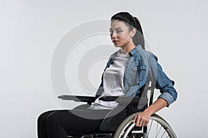 Serious crippled woman using wheelchair