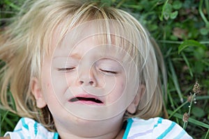 Serious crying sad young baby caucasian blonde real people girl close portrait outdoor