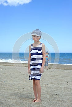 Serious cute little girl on the beach