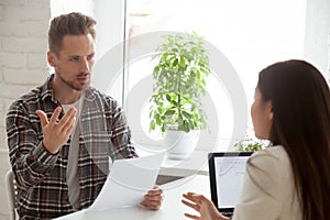 Dissatisfied employee expressing disagreement on work contract photo