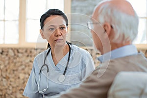 Serious doctor diagnosing senior man