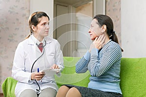 Serious doctor examining mature woman