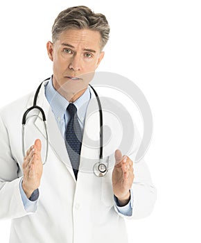 Serious Doctor Gesturing Against White Background