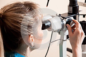 Serious Doctor at work machine for checking vision