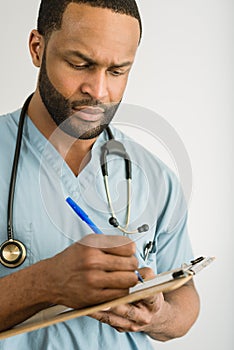 Serious Doctor Writing A Prescription