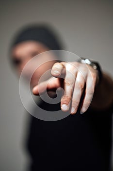 Serious dramatic man looking away while standing against black studio background