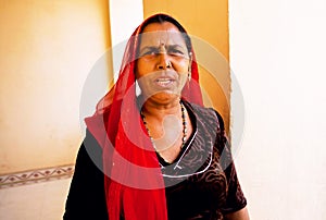 Serious elderly woman in indian headscarf