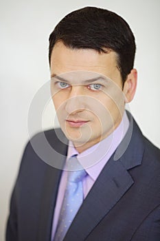 Serious elegance brunet man in suit looks up next photo