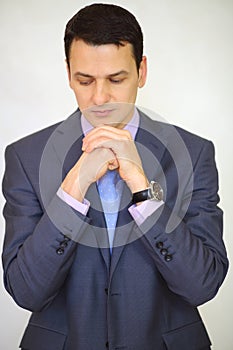 Serious elegance brunet man in suit posing with photo