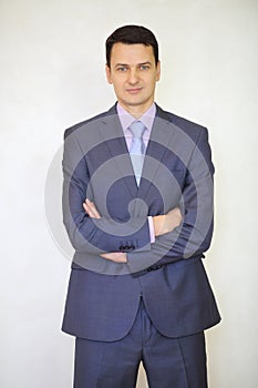 Serious elegance brunet man in suit with tie poses photo