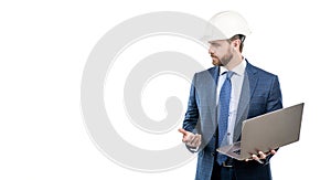 Serious engineer man in hardhat and suit use laptop computer for constructing, engineering