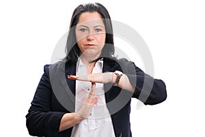 Serious entrepreneur woman making time out gesture with palms