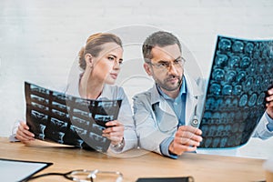 serious experienced doctors examining x-ray scans