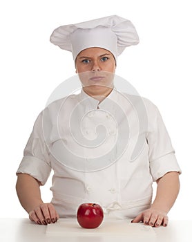 Serious fat female cook with red apple