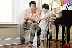 Serious father talking to teenage son at home