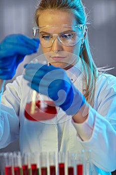 Serious female chemist working in laboratory