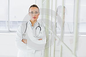 Serious female doctor with arms crossed in hospital